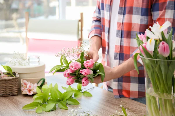 Decorador masculino creando hermoso ramo en la mesa — Foto de Stock