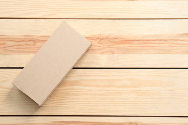 Cardboard box on wooden background — Stock Photo, Image