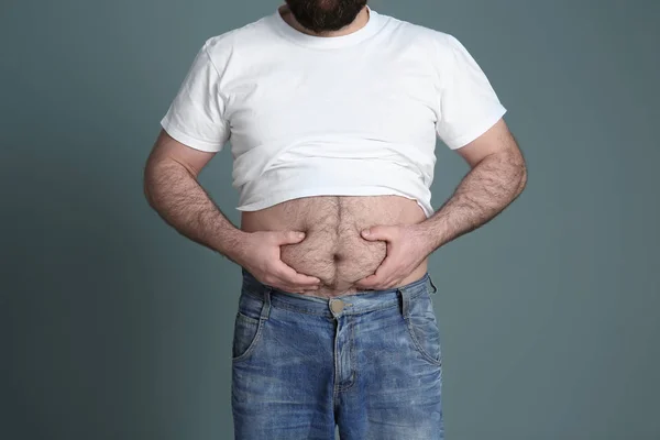 Overgewicht man op kleur achtergrond — Stockfoto