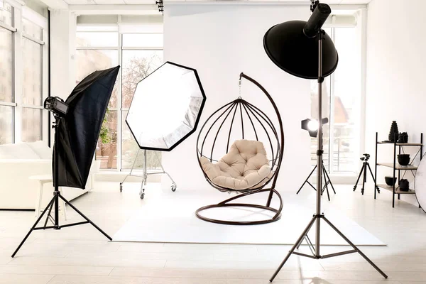 Hanging chair in photo studio with professional equipment — Stock Photo, Image