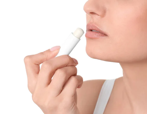 Woman applying hygienic lip balm, on white background — Stock Photo, Image