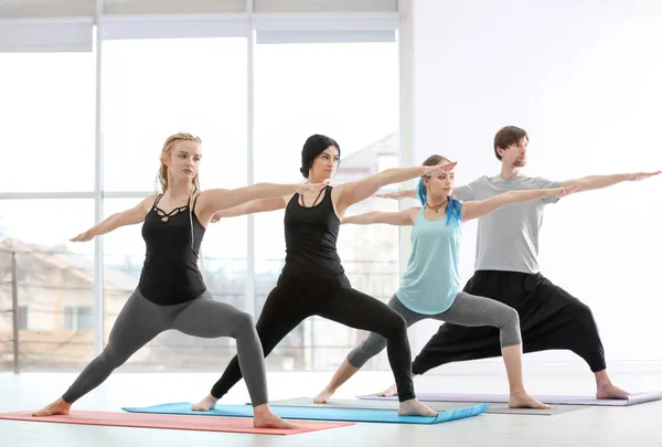 Grupo de personas que practican yoga en interiores — Foto de Stock