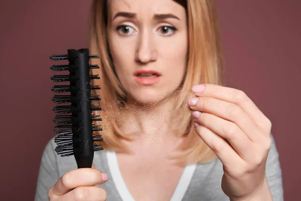 Young woman with hair loss problem on color background — Stock Photo, Image