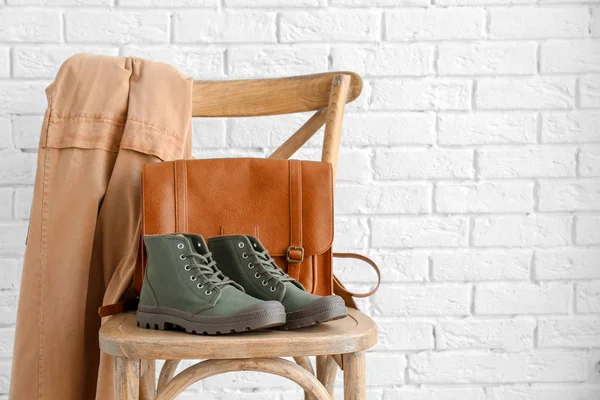 Comfortable casual female shoes and bag on chair against white brick wall — Stock Photo, Image