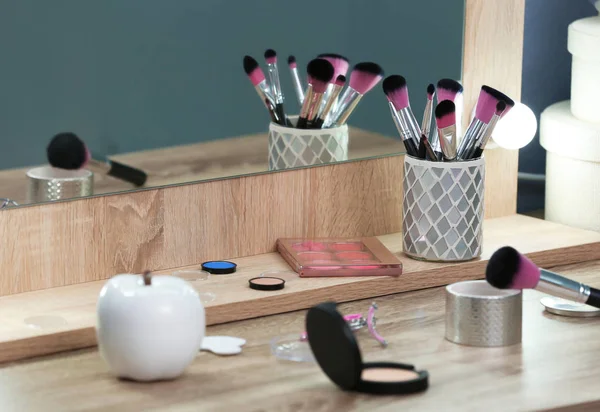 Decorative cosmetics and tools on dressing table in makeup room — Stock Photo, Image