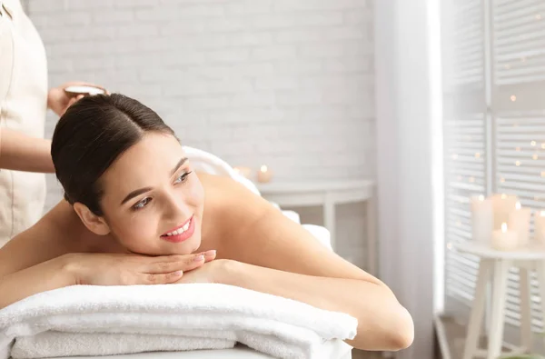 Young woman having body scrubbing procedure with sea salt in spa salon — Stock Photo, Image