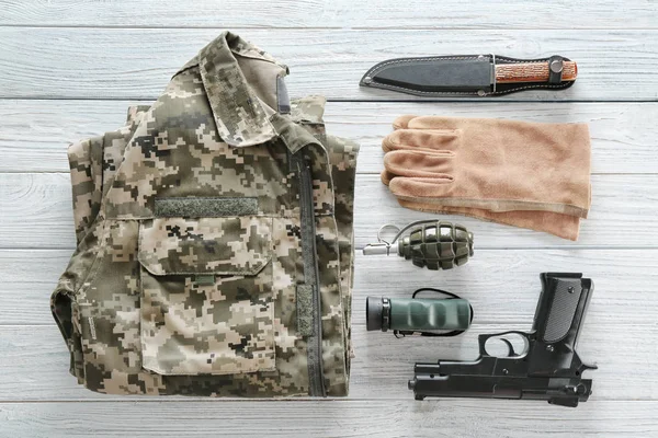 Set of military outfit on wooden background, flat lay — Stock Photo, Image