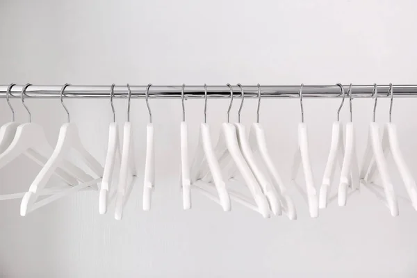 Clothes rail with hangers on white background — Stock Photo, Image