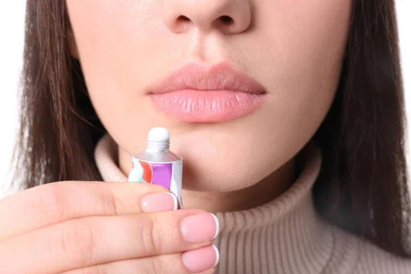 Young woman applying cold sore cream on lips, closeup — Stock Photo, Image