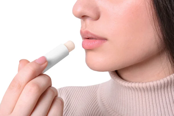 Young woman applying cold sore balm on lips against white background, closeup — Stock Photo, Image