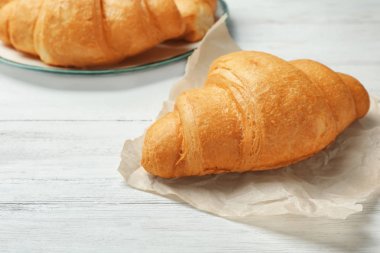 Ahşap masa üzerinde lezzetli kruvasan