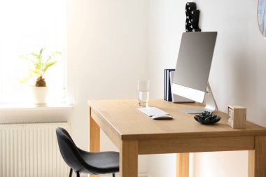 Ev ofisindeki masada bilgisayarla rahat bir iş yeri.