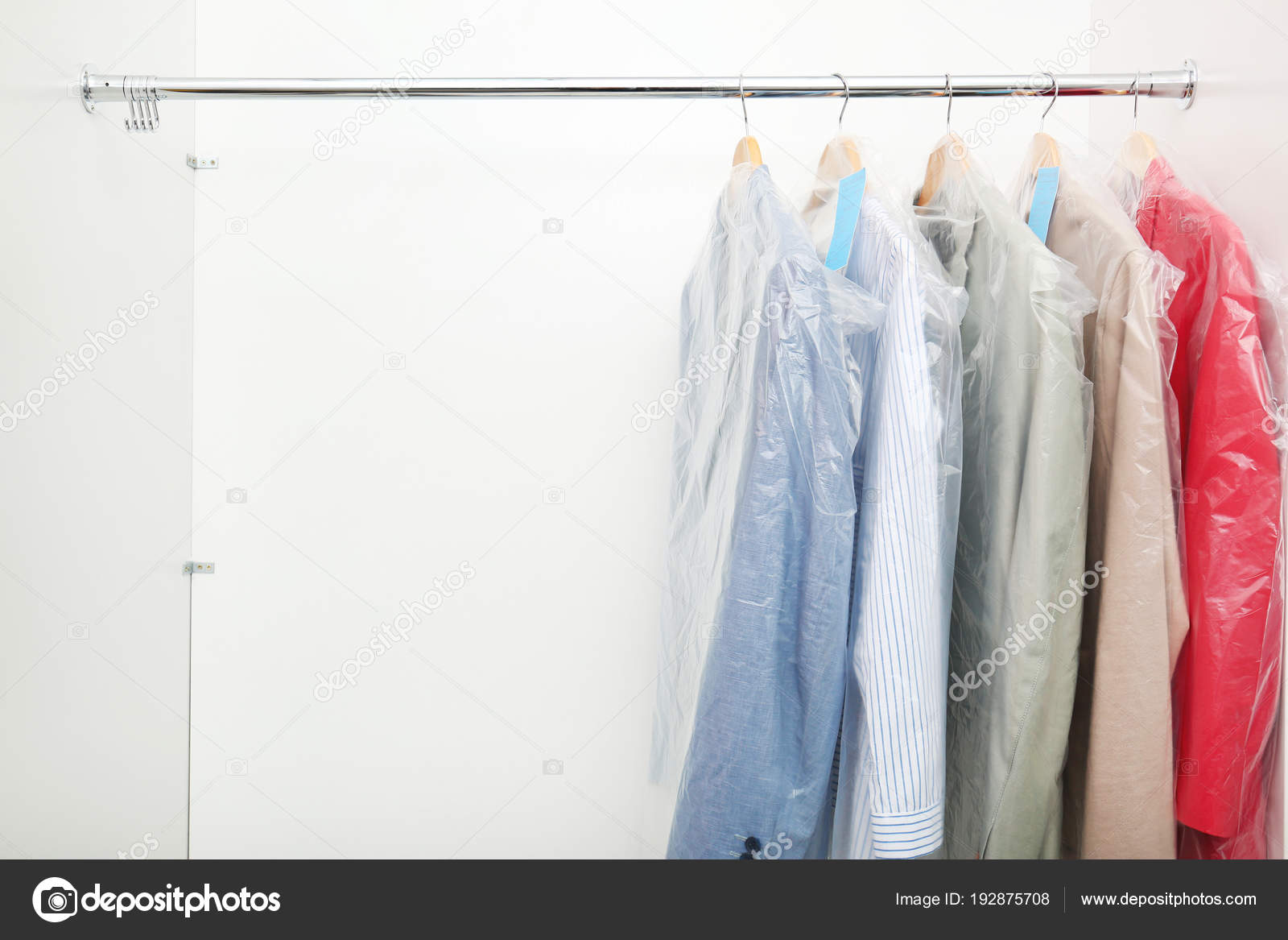 Rack With Clean Clothes After Dry Cleaning On Hangers In Wardrobe
