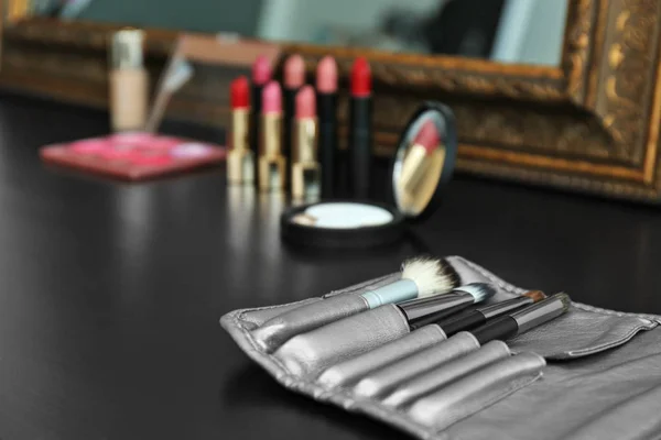 Brushes on dressing table in makeup room, closeup