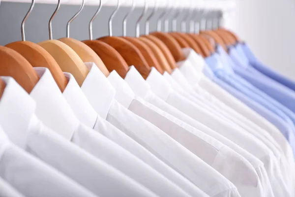 Clean clothes on hangers after dry-cleaning, closeup — Stock Photo, Image