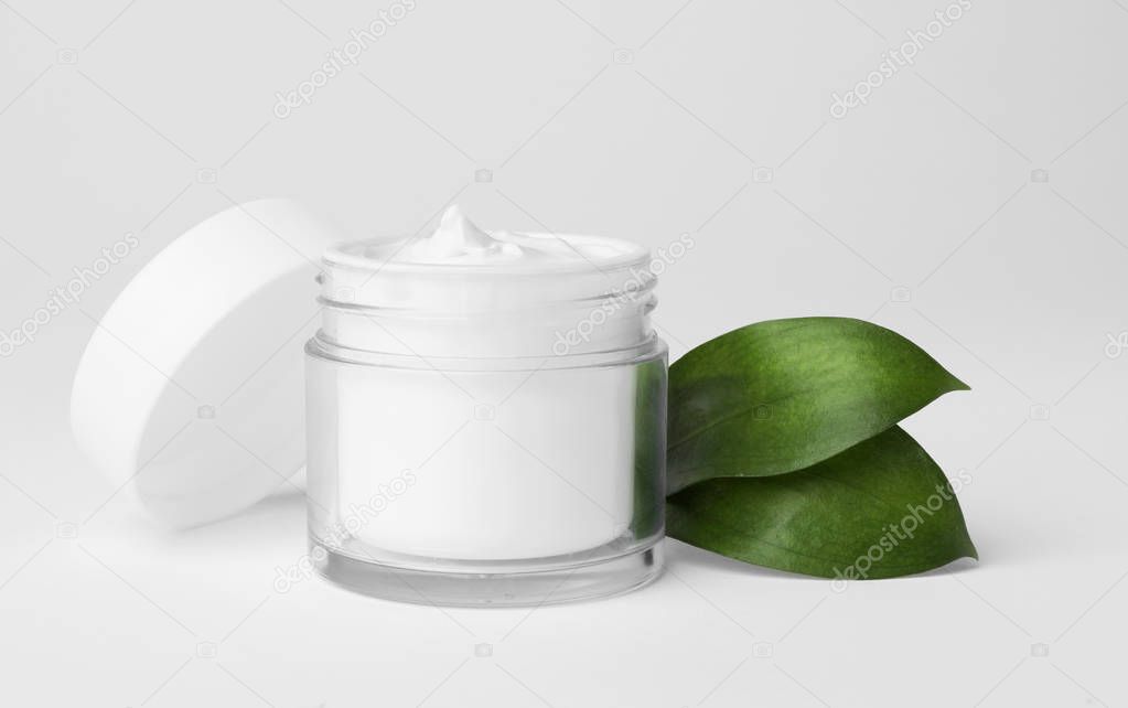 Jar of cosmetic product on light background