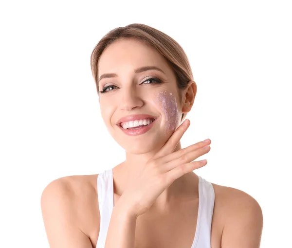 Ung kvinna applicera naturliga skrubb på hennes ansikte mot vit bakgrund — Stockfoto