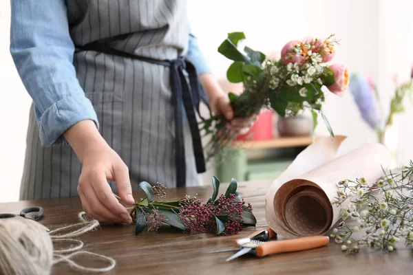 Floristería femenina creando hermoso ramo en la mesa — Foto de Stock