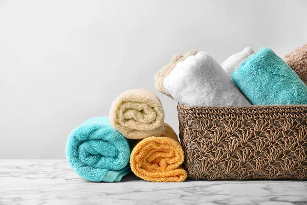 Clean towels on table against light background — Stock Photo, Image