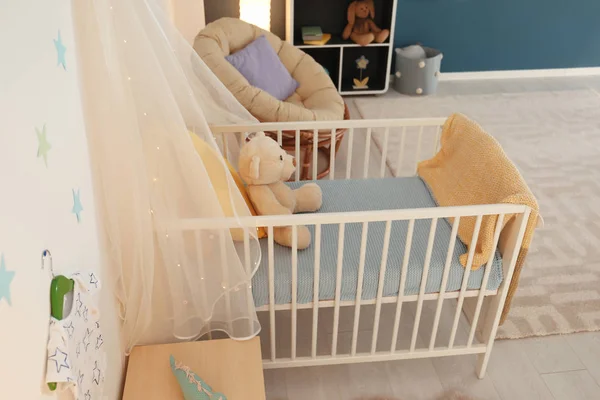 Stylish baby room interior with crib — Stock Photo, Image