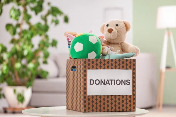 Donation box with toys on table indoors