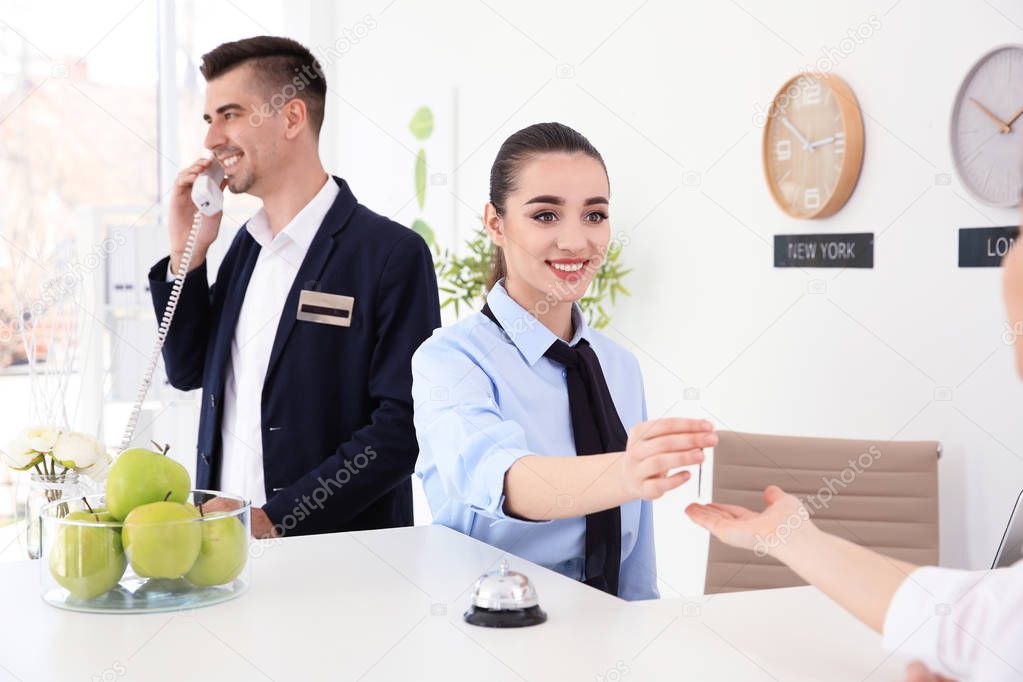 Busy receptionists at workplace in hotel