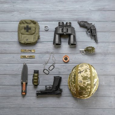 Ahşap arka plan, düz üzerinde askeri teçhizat kümesi yatıyordu