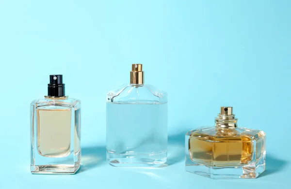 Bottles of perfume on color background — Stock Photo, Image