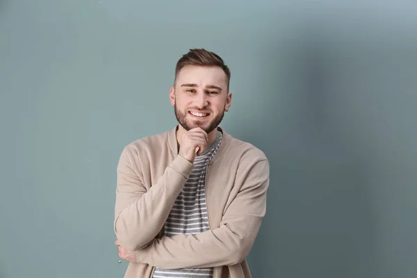 Portrait of confident young man on color background — Stock Photo, Image
