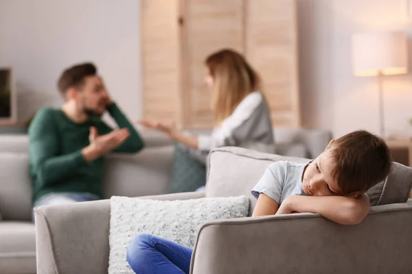 Lite Olycklig Pojke Sitter Fåtölj Medan Föräldrar Argumentera Hemma — Stockfoto