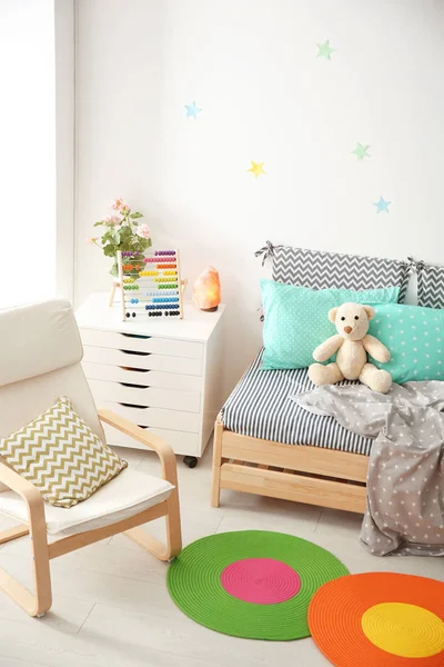 现代儿童房内有舒适的床和扶手椅 — 图库照片