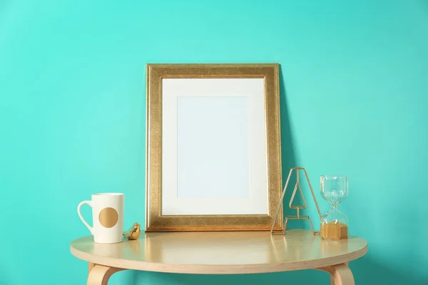 Mockup of blank frame and hourglass on table — Stock Photo, Image