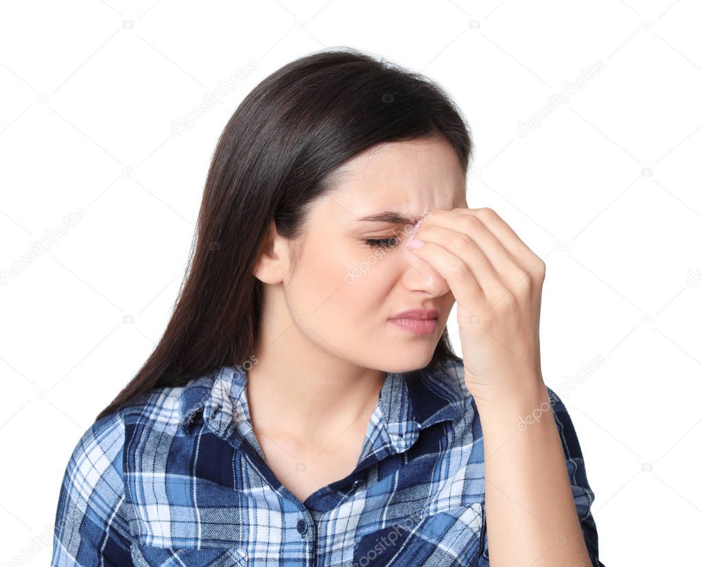 Beautiful young woman suffering from headache on white background