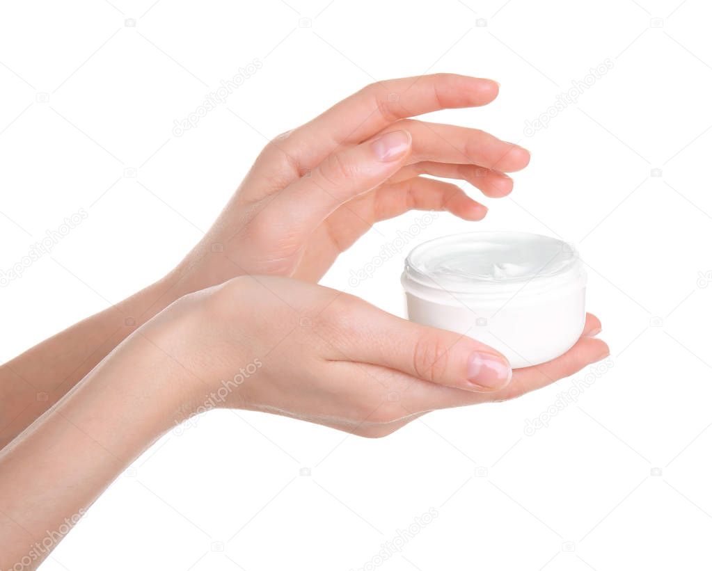 Young woman holding jar with hand cream on white background