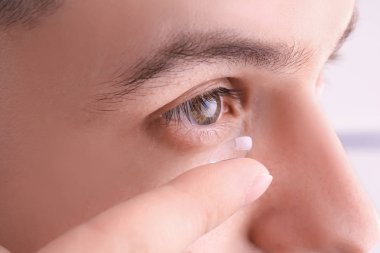 Onun gözünde, closeup koyarak Kontakt lens genç adam