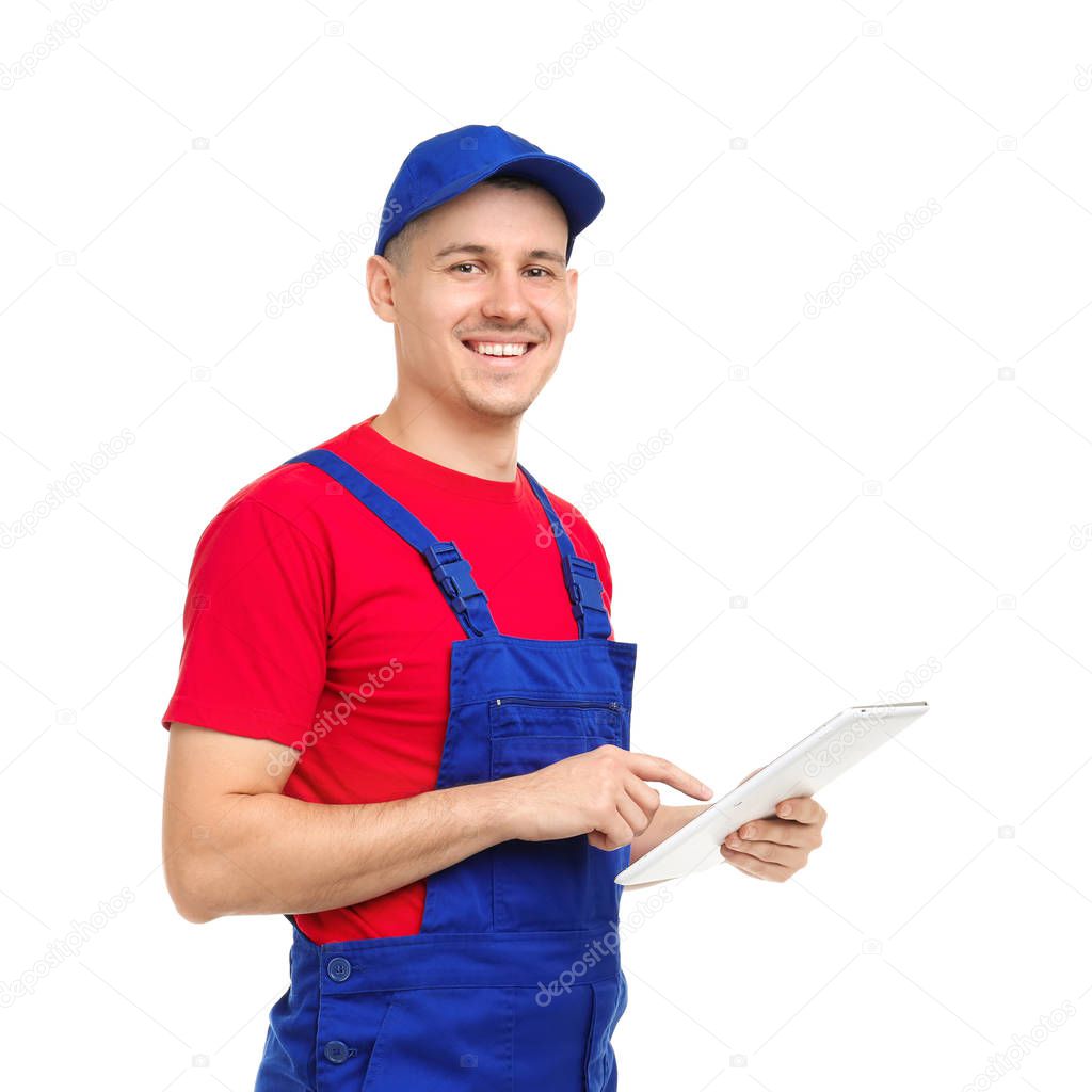 Young plumber with tablet computer on white background