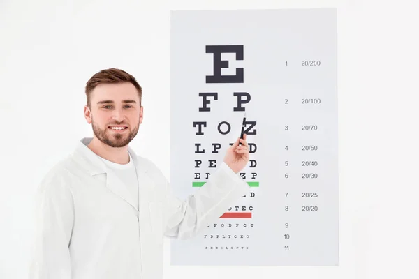 Fiatal férfi szemész szem diagram a klinika közelében — Stock Fotó