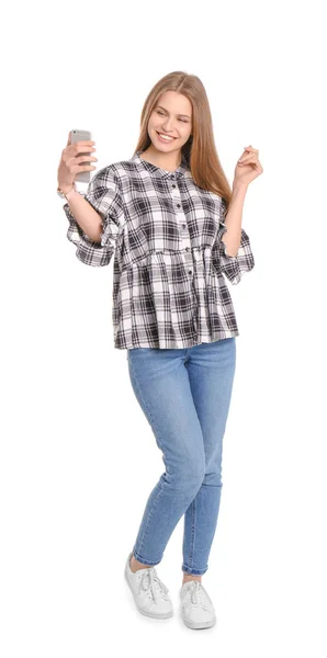 Young beautiful woman taking selfie against white background — Stock Photo, Image