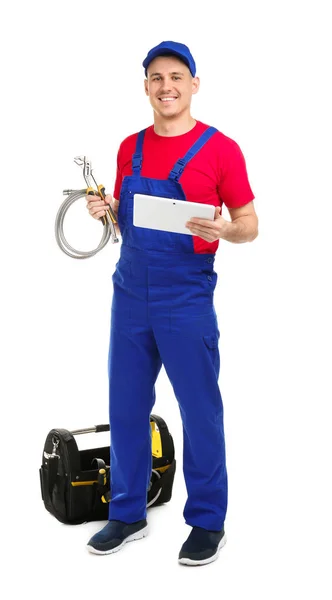 Young plumber with tablet computer on white background — Stock Photo, Image