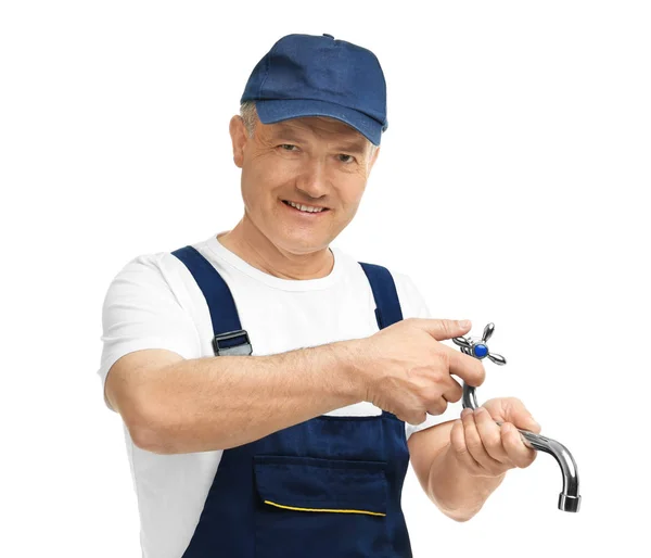 Mature plumber with faucet on white background — Stock Photo, Image