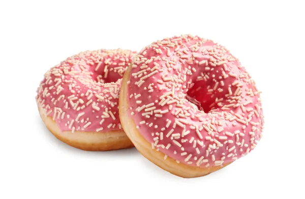 Köstliche glasierte Donuts mit Streusel auf weißem Hintergrund — Stockfoto