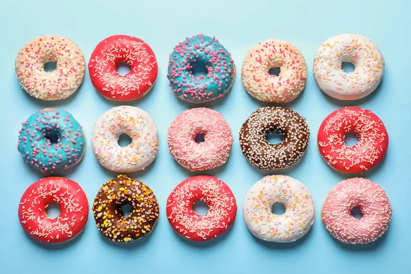 Deliciosos donuts envidraçados no fundo da cor, vista superior — Fotografia de Stock