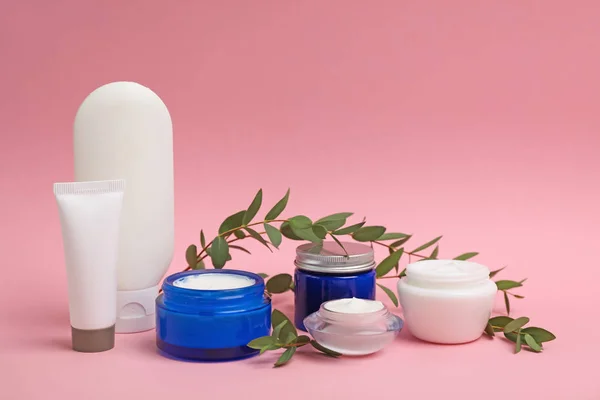 Composition with cosmetic products on color background