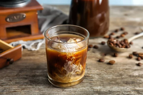 Glass with cold brew coffee and milk on wooden table — Stock Photo, Image