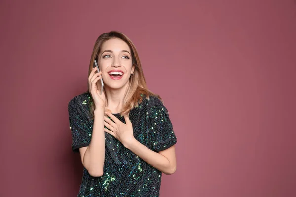 Junge Frau telefoniert vor farbigem Hintergrund — Stockfoto