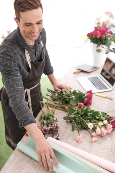 Floristería masculina creando hermoso ramo en la tienda de flores — Foto de Stock