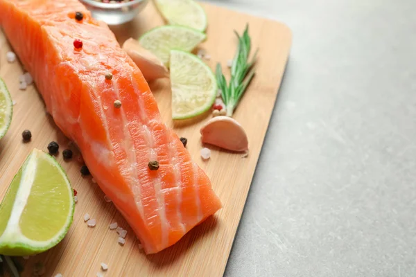 Fresh salmon and ingredients for marinade on wooden board — Stock Photo, Image