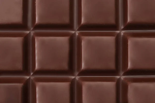 Вкусный темный шоколад в качестве фона — стоковое фото