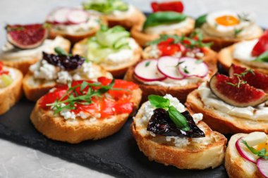 Açık gri mermer masada farklı bruschettalar, yakın plan.