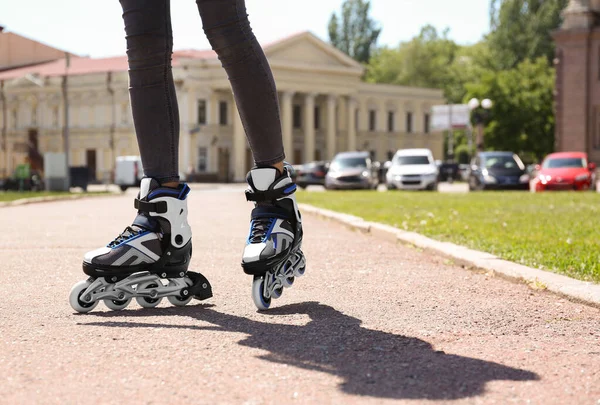 Woman with modern inline roller skates in city park, closeup — Stock Photo, Image